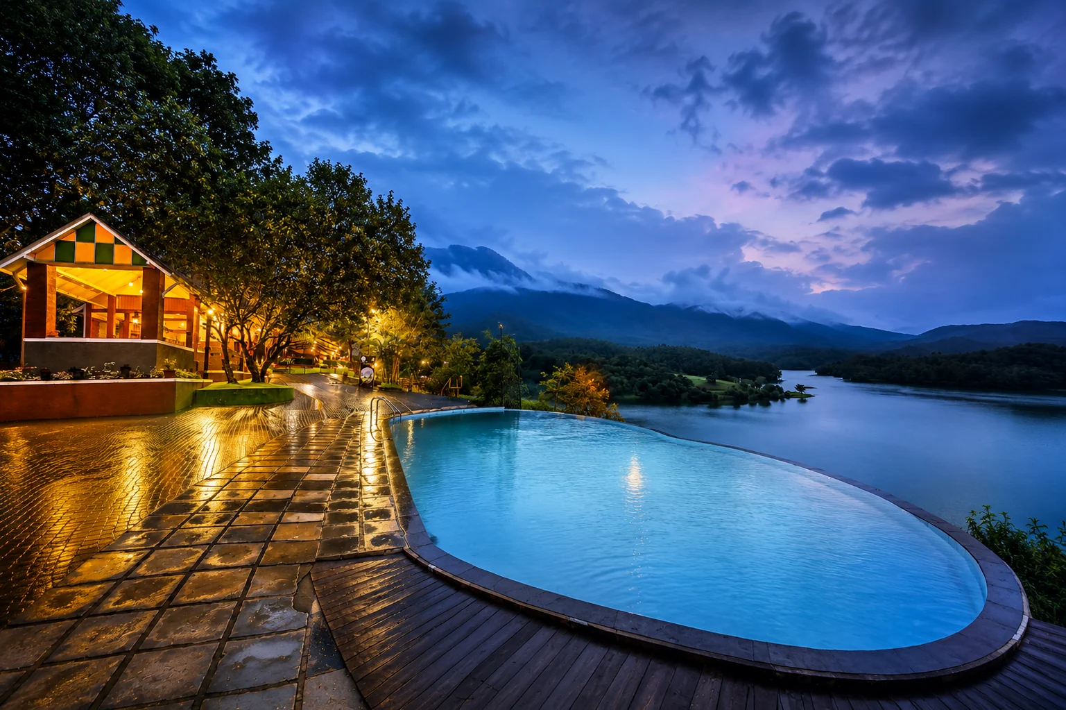 Infinity pool overlooking Banasura Sagar Dam at twilight